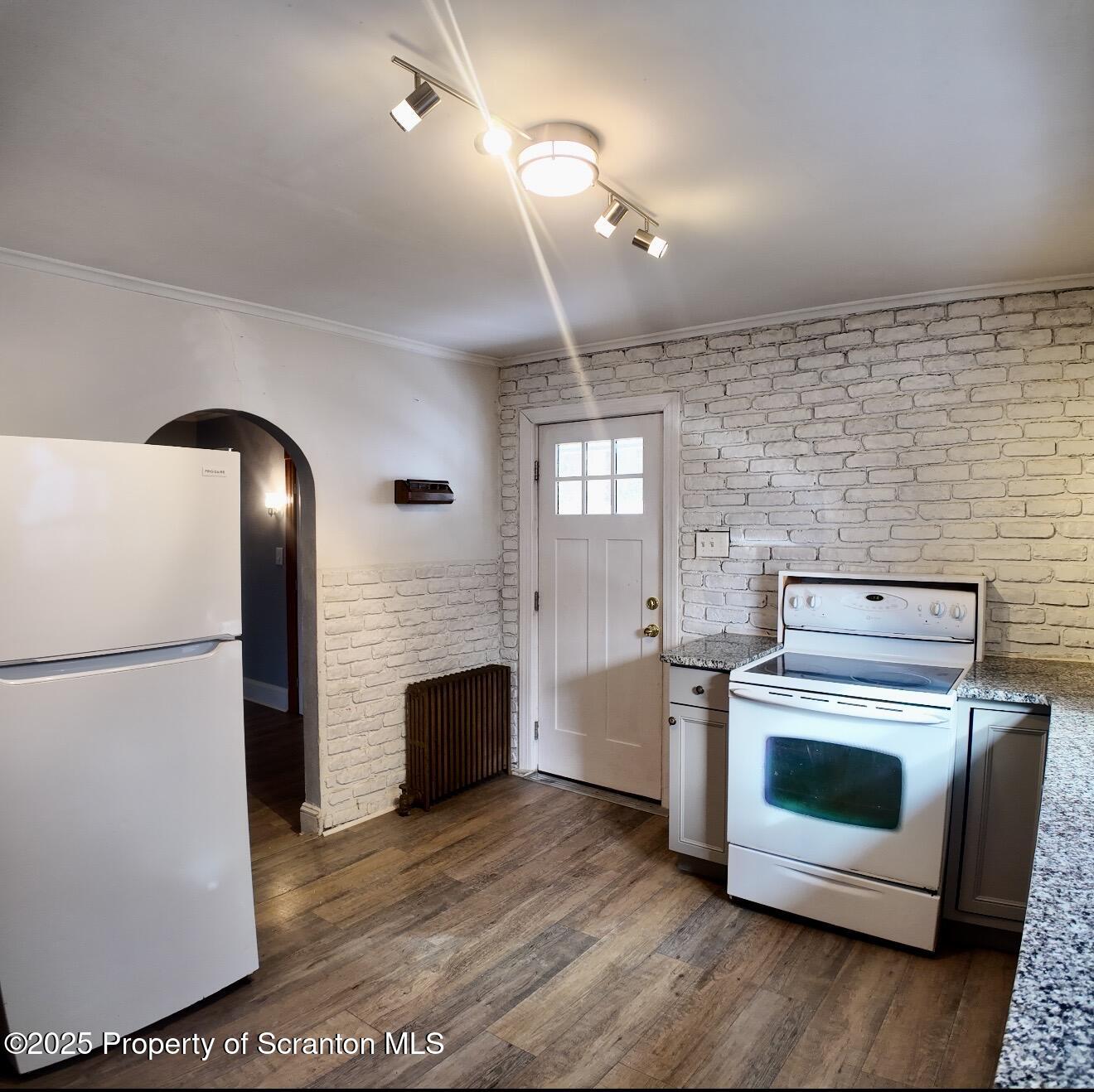 58 Owego Street Simpson, PA 18407 - Photo 3 of 16 a kitchen with a stove and a refrigerator
