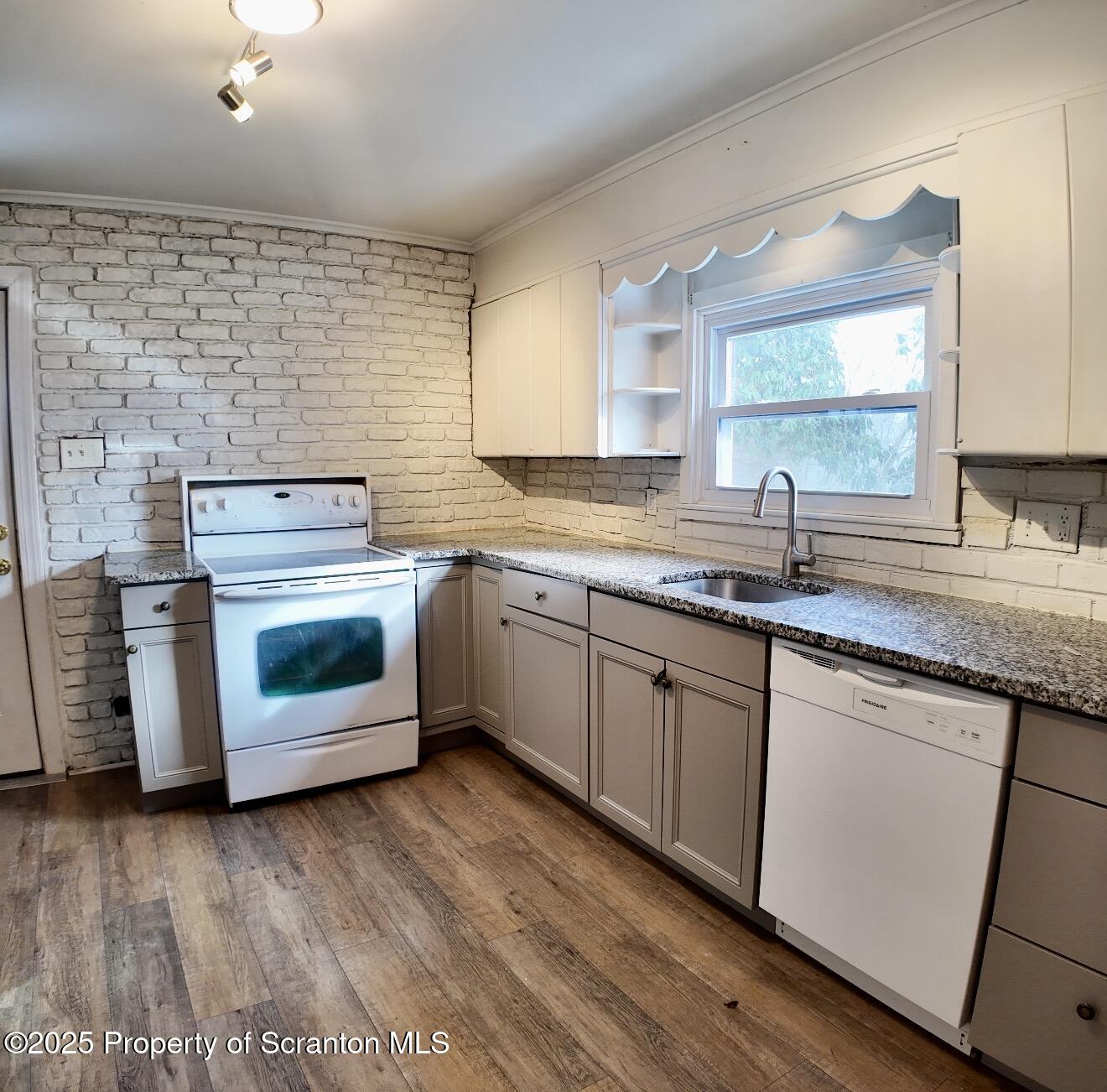 58 Owego Street Simpson, PA 18407 - Photo 4 of 16 a kitchen with a stove top oven sink and window