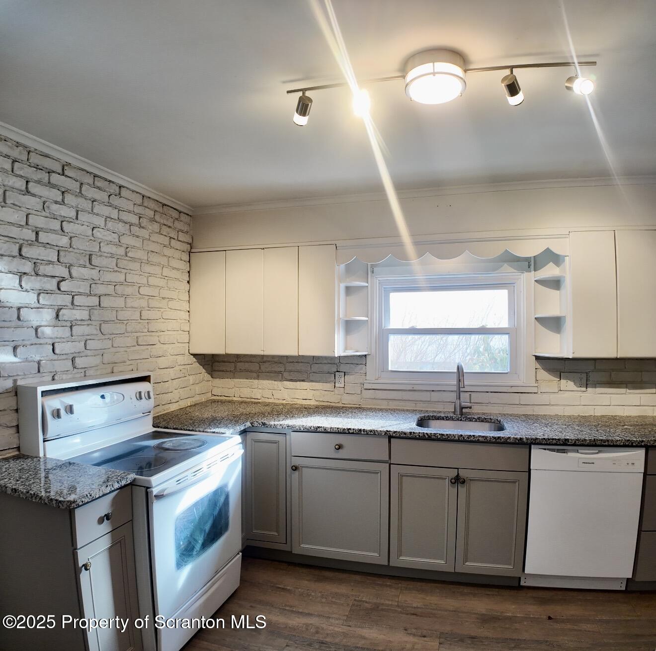 58 Owego Street Simpson, PA 18407 - Photo 5 of 16 a kitchen with granite countertop a sink cabinets and stainless steel appliances