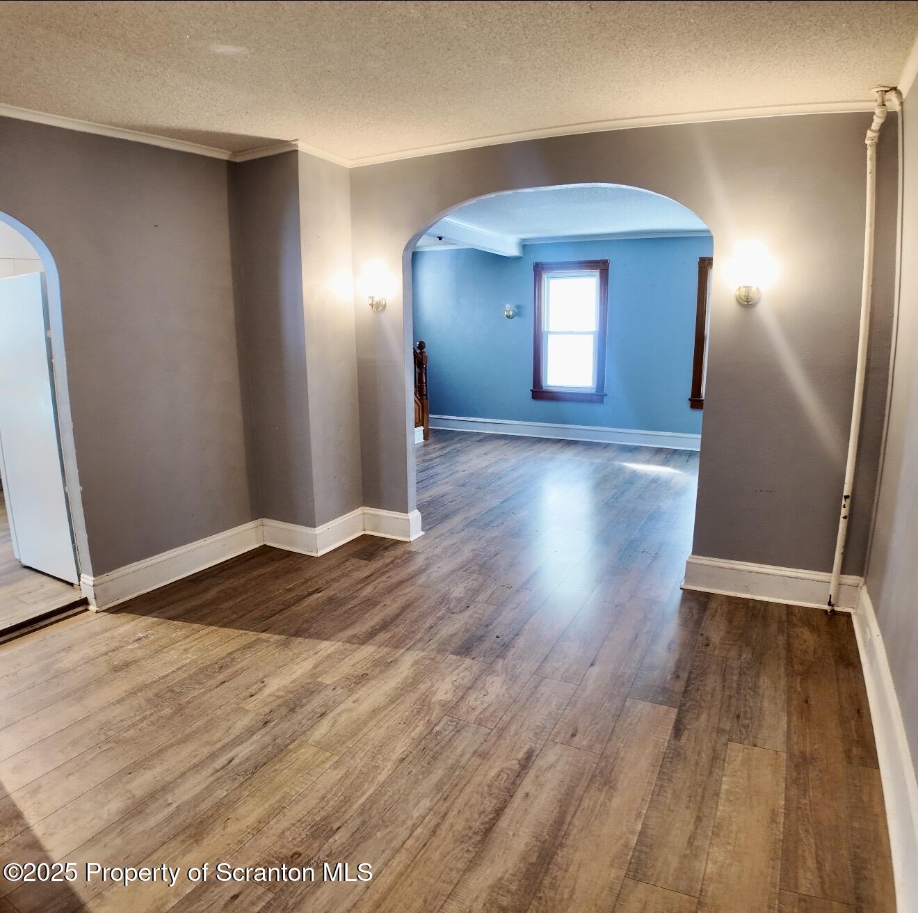 58 Owego Street Simpson, PA 18407 - Photo 7 of 16 a view of an empty room with wooden floor and a window