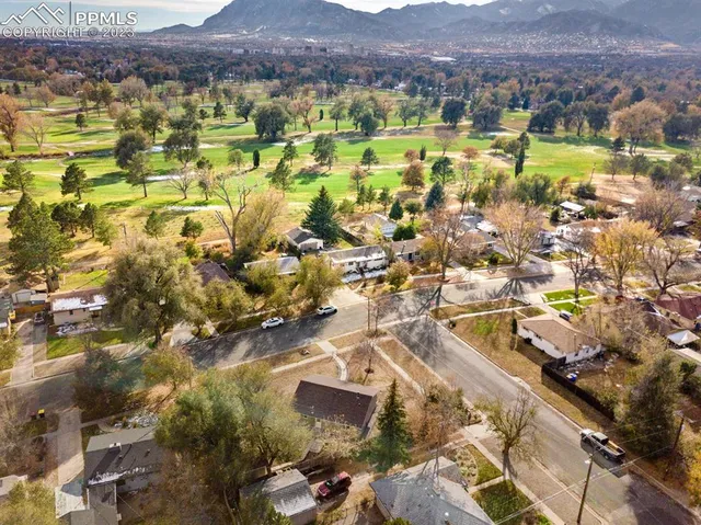 a view of a house with a tree in the background