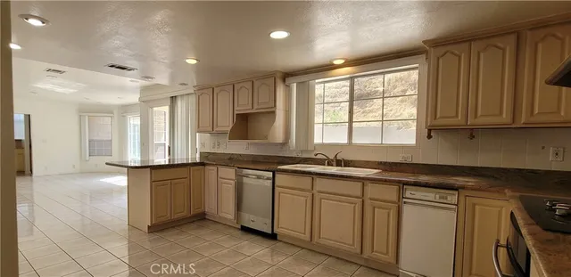 a kitchen with stainless steel appliances granite countertop a sink and cabinets