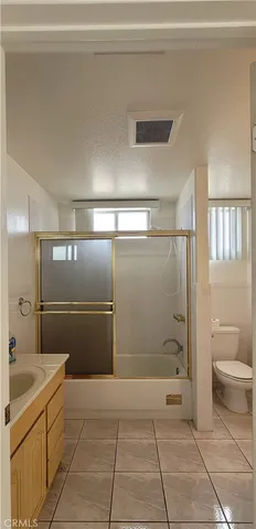 a bathroom with a toilet a sink and shower