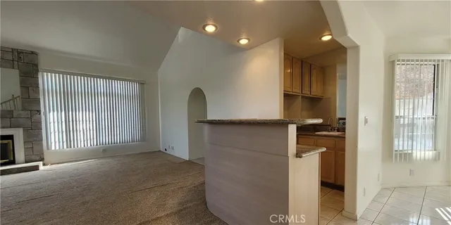 a kitchen with windows and refrigerator