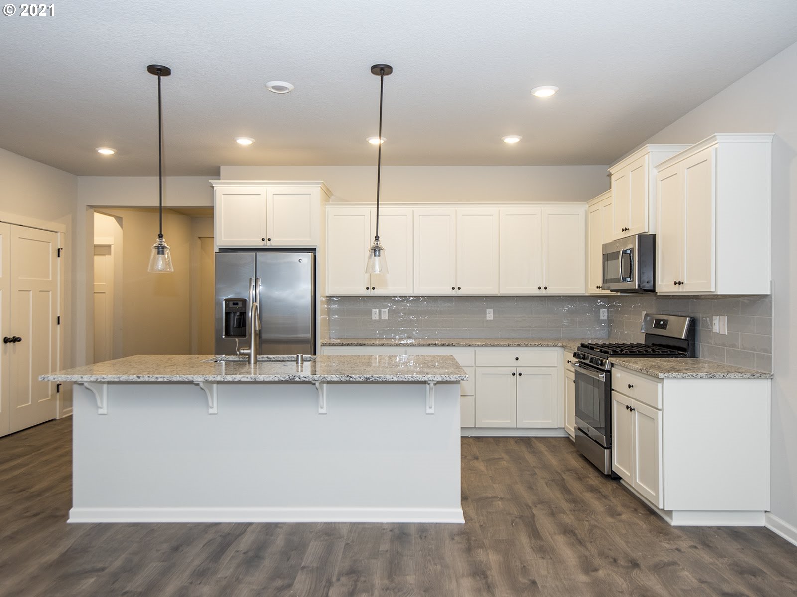 3739 South 42nd Place Ridgefield, WA 98642 - Photo 22 of 30 a kitchen with stainless steel appliances granite countertop a sink a stove and a refrigerator
