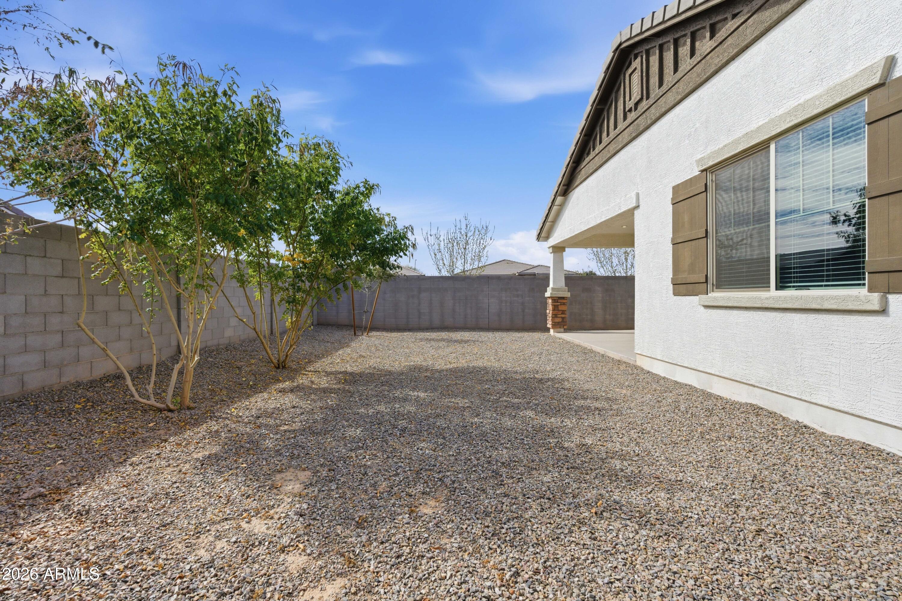 22445 East Marsh Road Queen Creek, AZ 85142 - Photo 49 of 71 a view of a house with a yard and wooden fence