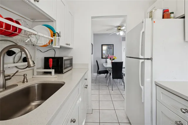 a kitchen with stainless steel appliances a sink a refrigerator and a refrigerator