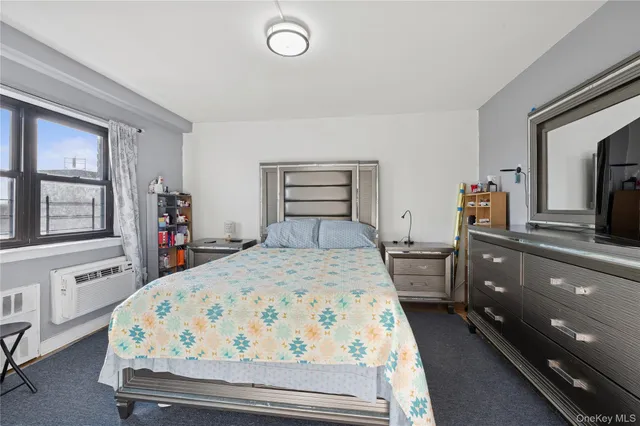 a bed room with a bed and dresser