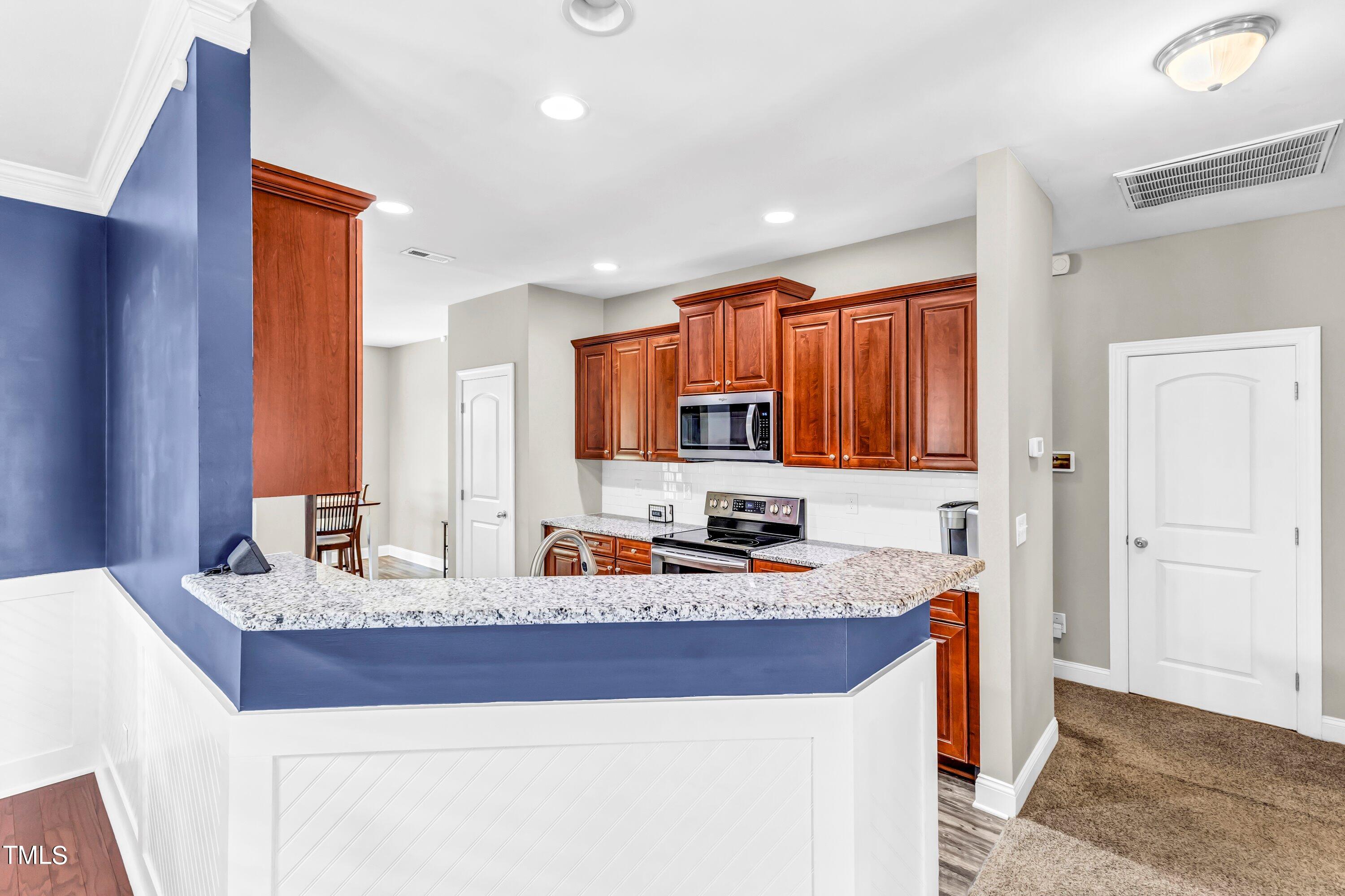 4151 White Kestrel Drive Raleigh, NC 27616 - Photo 11 of 37 a kitchen with sink a stove and cabinets