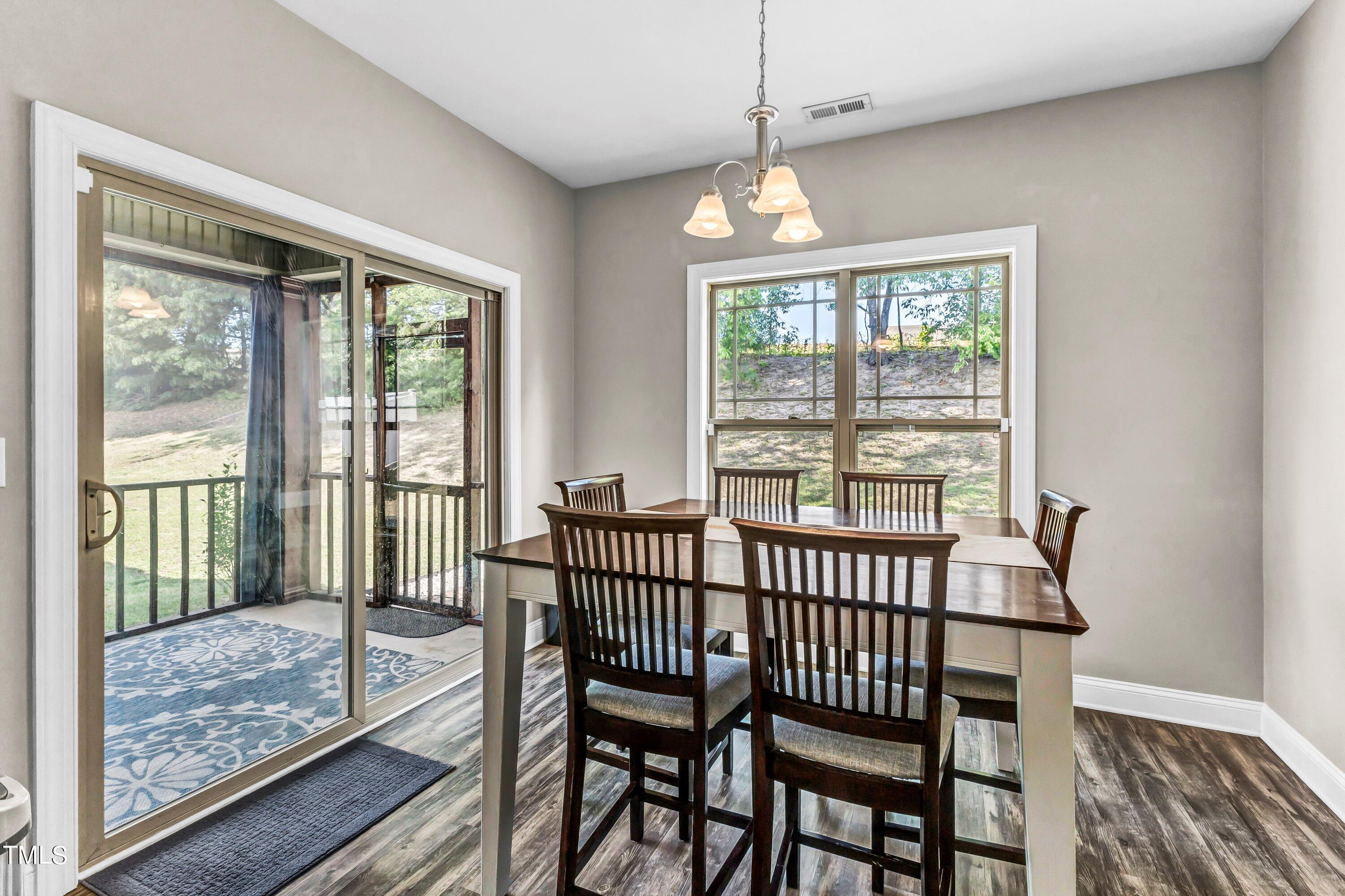 4151 White Kestrel Drive Raleigh, NC 27616 - Photo 15 of 37 a view of a dining room with furniture window and wooden floor