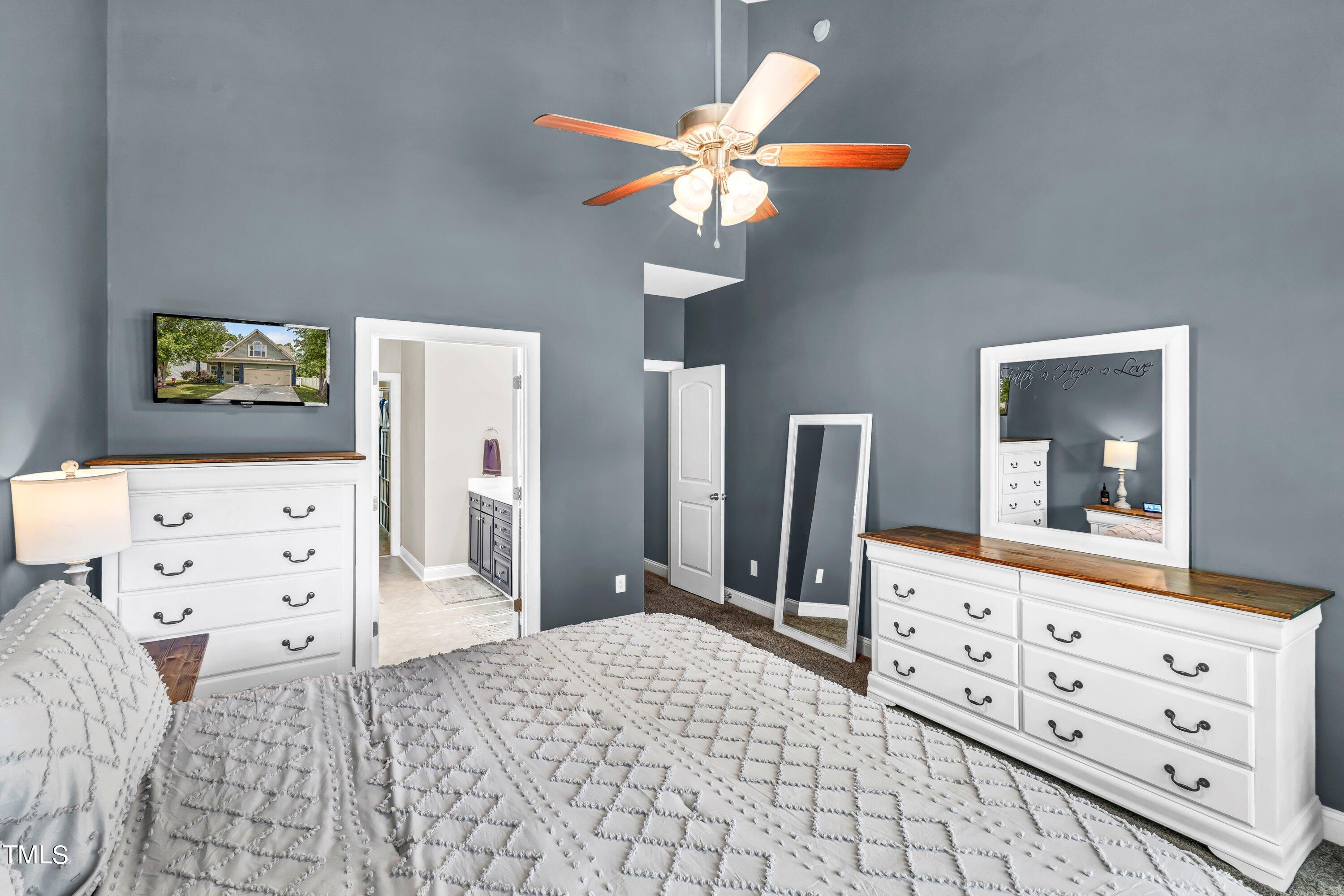 4151 White Kestrel Drive Raleigh, NC 27616 - Photo 18 of 37 a bedroom with a bed and a flat tv screen on dresser