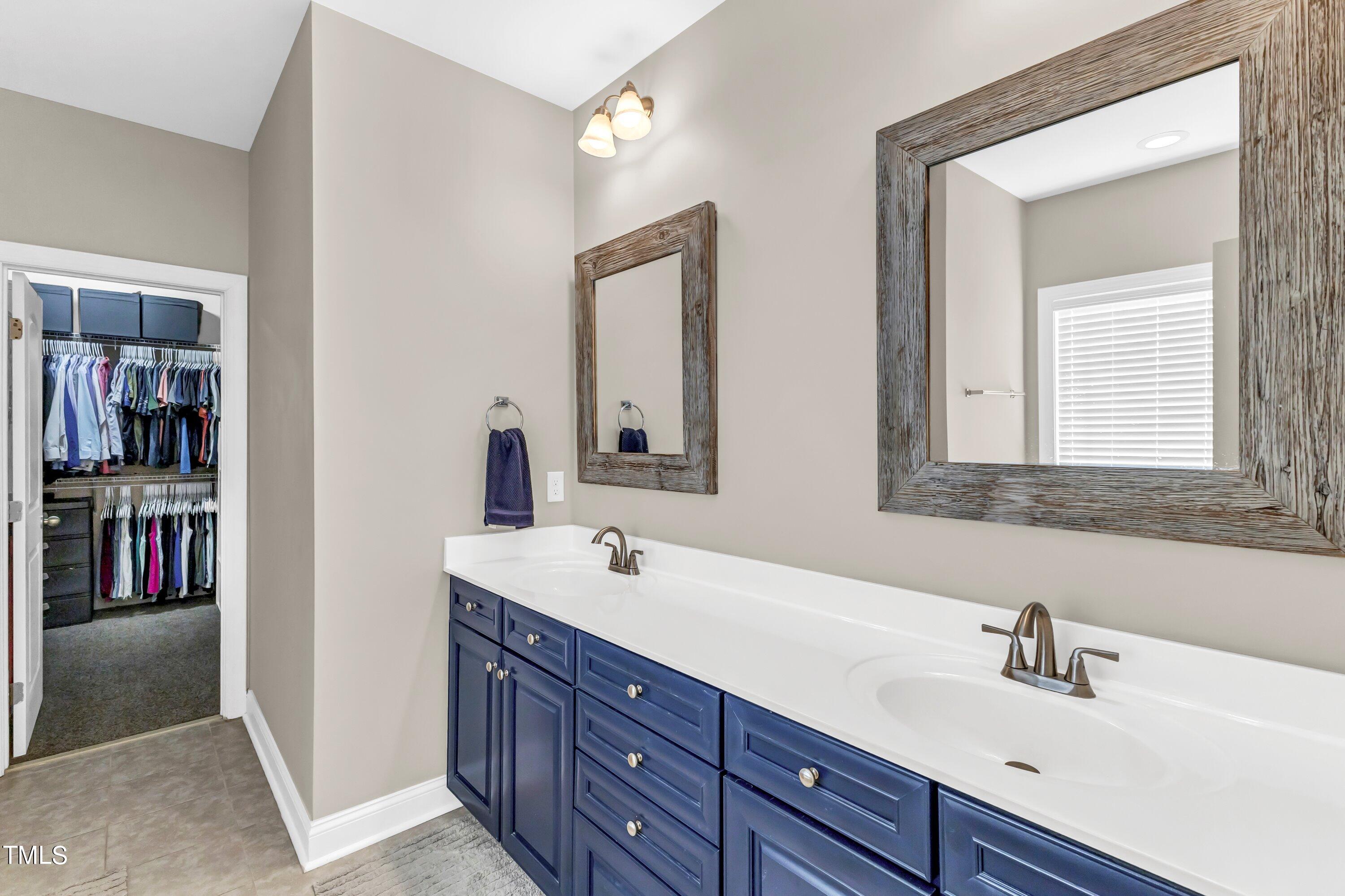 4151 White Kestrel Drive Raleigh, NC 27616 - Photo 19 of 37 a bathroom with a sink and a mirror