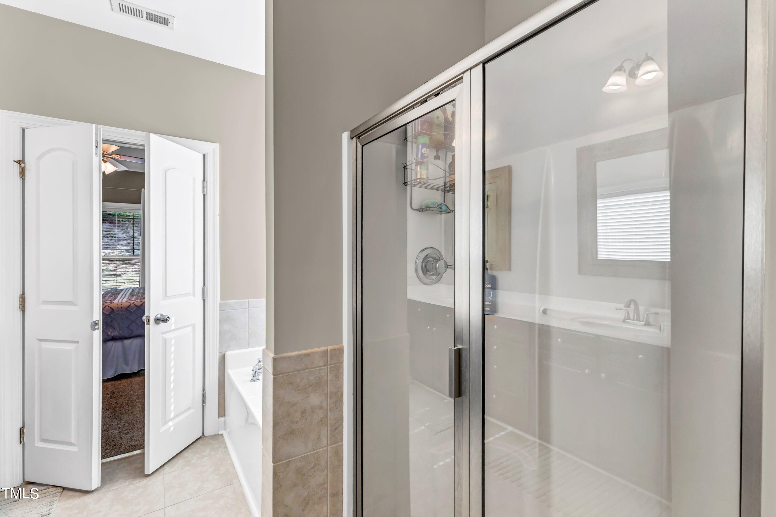 4151 White Kestrel Drive Raleigh, NC 27616 - Photo 20 of 37 a bathroom with a shower and a sink