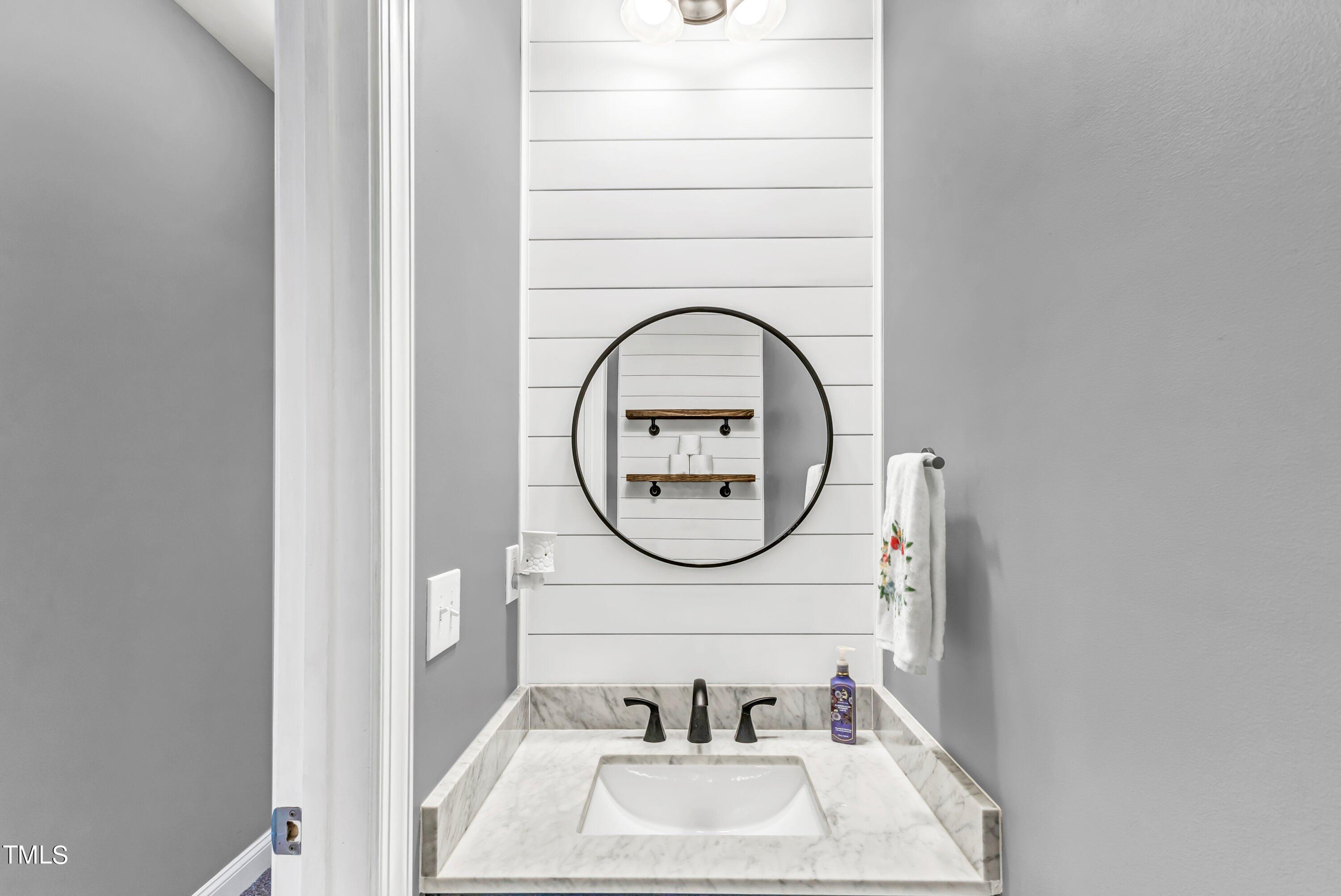 4151 White Kestrel Drive Raleigh, NC 27616 - Photo 22 of 37 a bathroom with a sink and a mirror