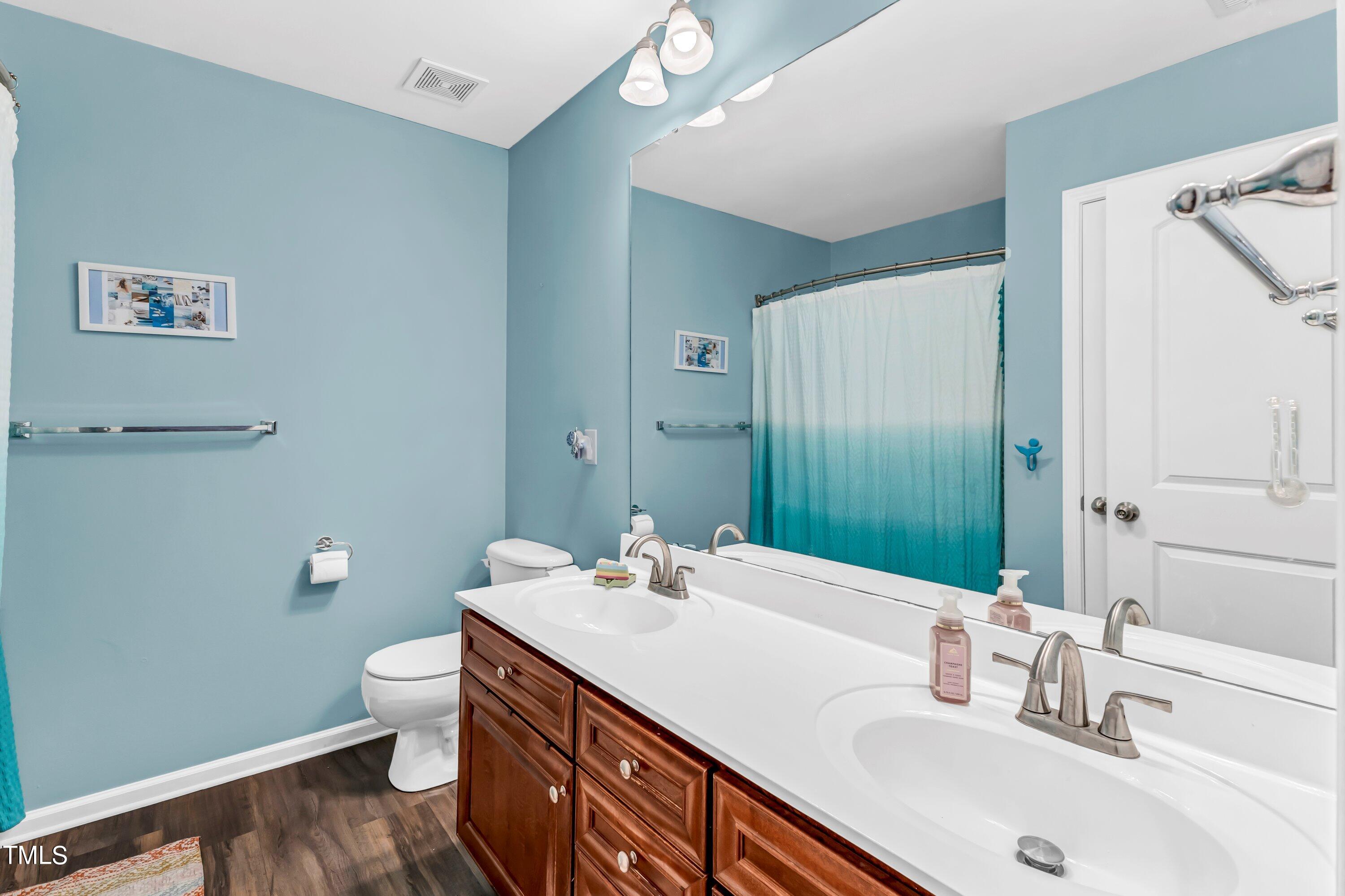4151 White Kestrel Drive Raleigh, NC 27616 - Photo 29 of 37 a bathroom with a sink and a mirror