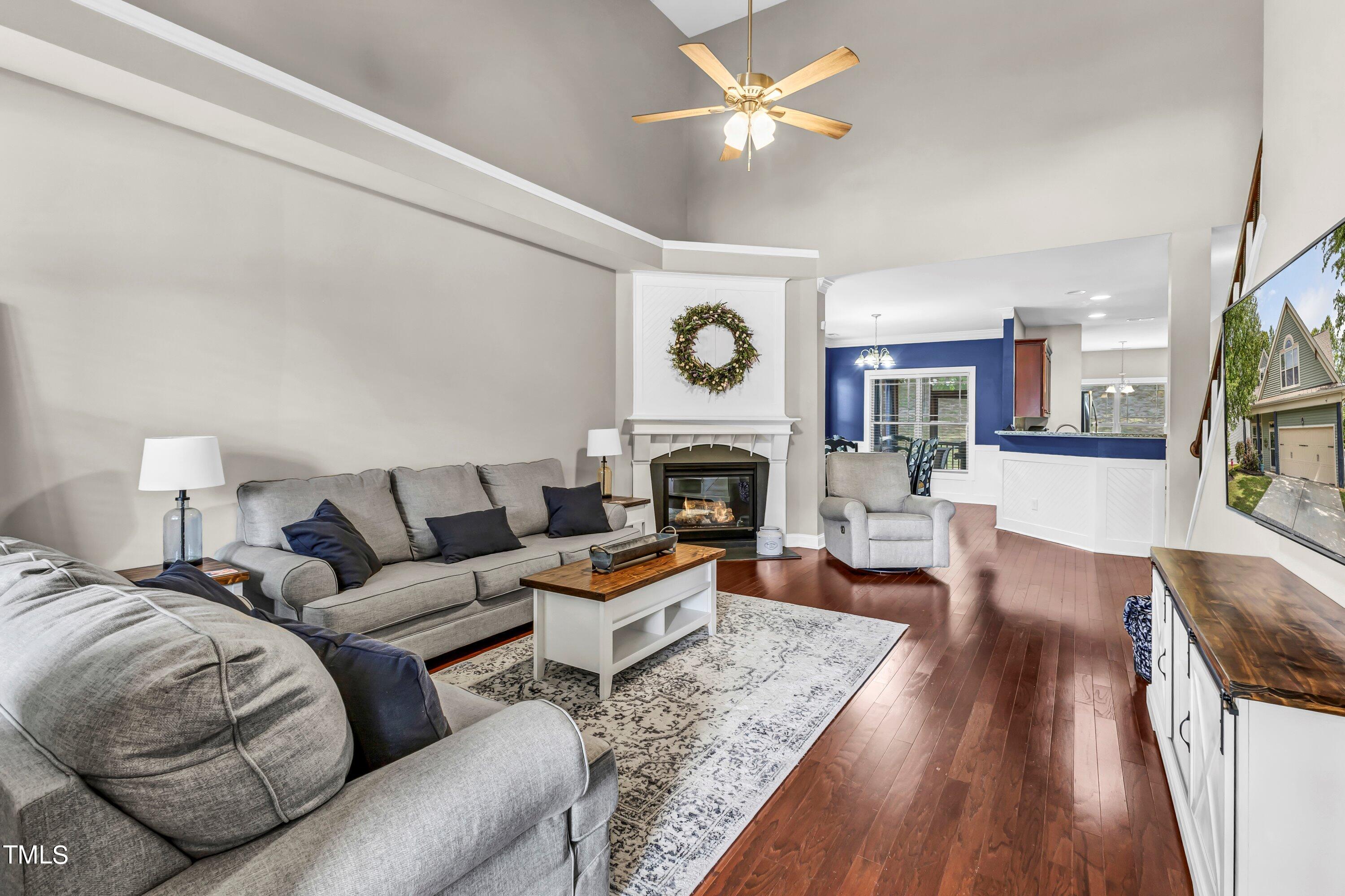 4151 White Kestrel Drive Raleigh, NC 27616 - Photo 4 of 37 a living room with furniture a fireplace and a large window