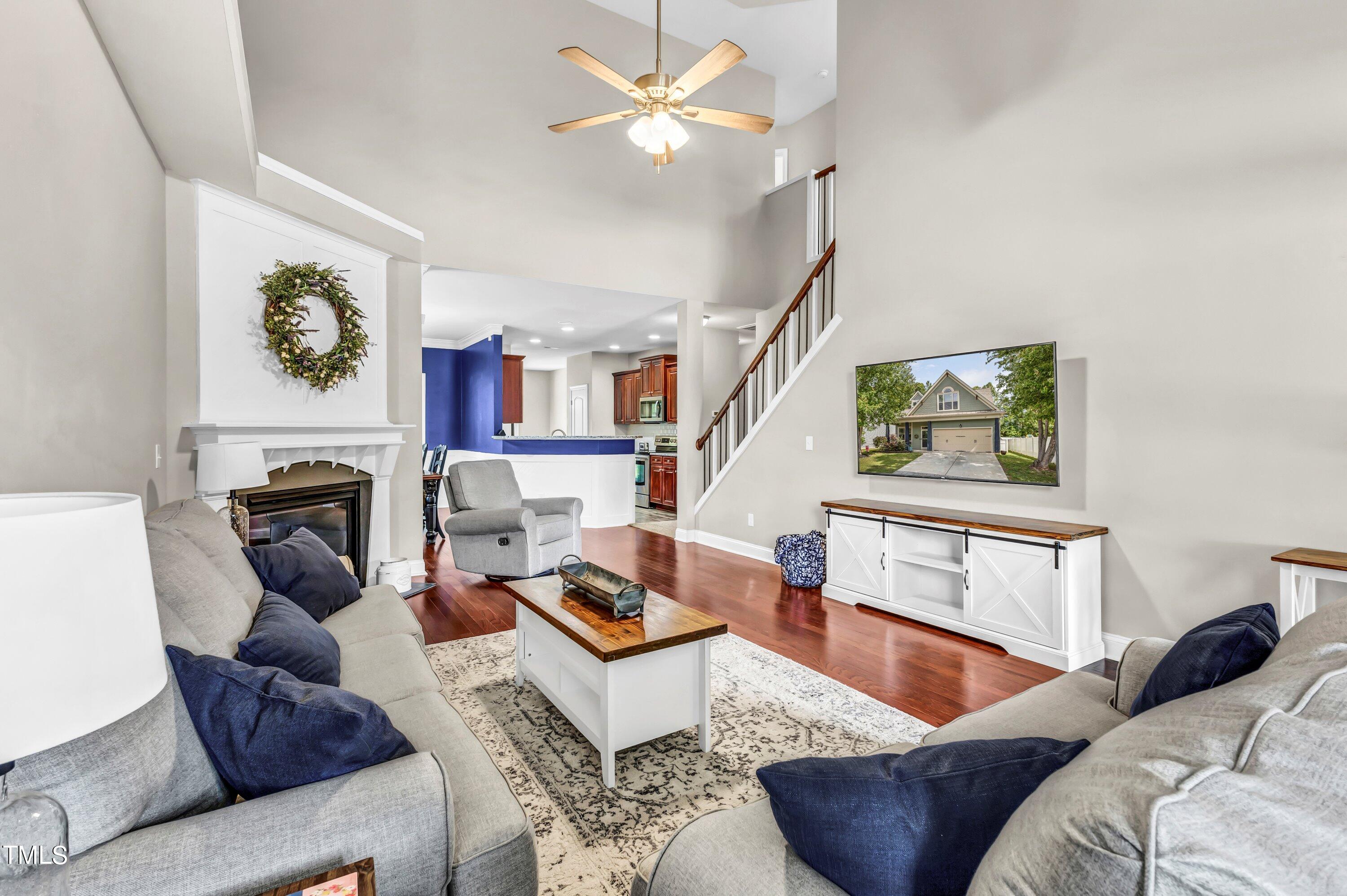 4151 White Kestrel Drive Raleigh, NC 27616 - Photo 5 of 37 a living room with furniture a fireplace and a window