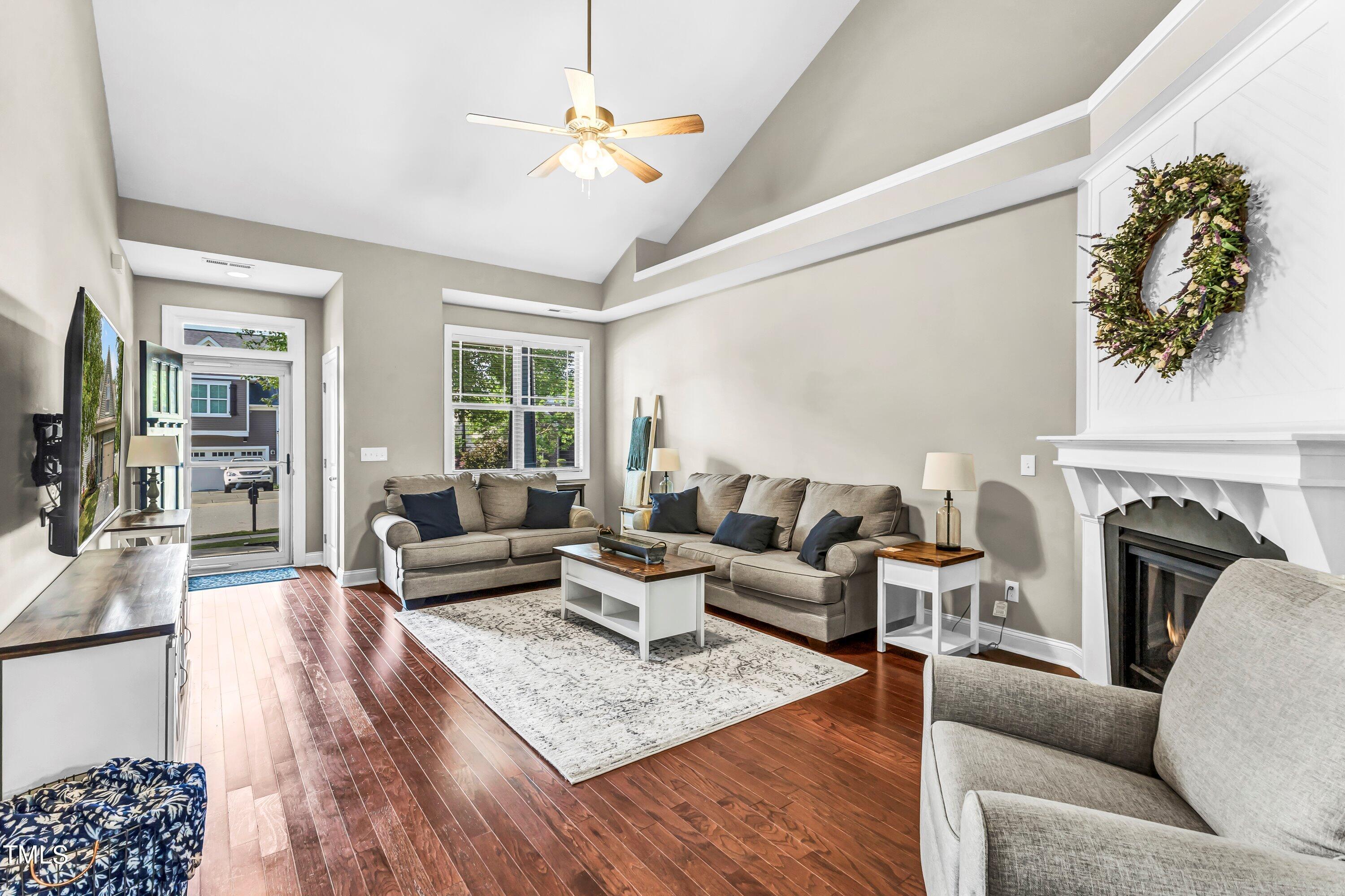 4151 White Kestrel Drive Raleigh, NC 27616 - Photo 7 of 37 a living room with furniture a fireplace and a chandelier