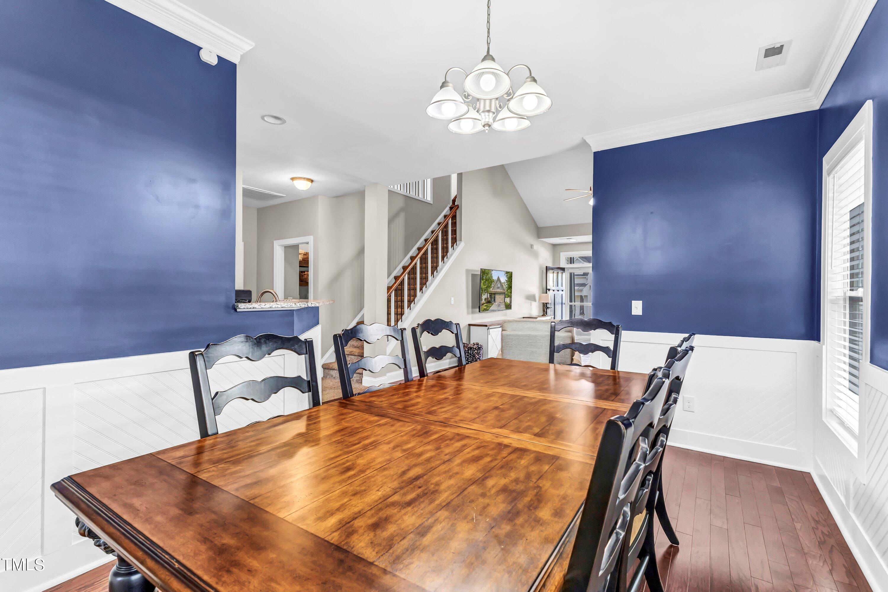 4151 White Kestrel Drive Raleigh, NC 27616 - Photo 10 of 37 a dining room with furniture a chandelier and wooden floor