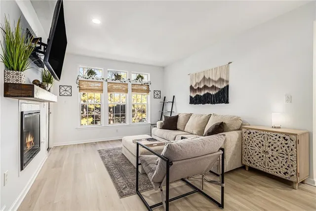 a living room with furniture a window and a flat screen tv