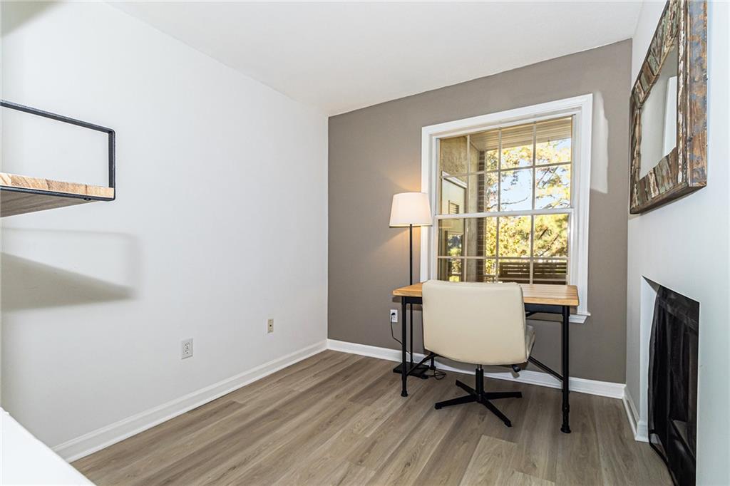 220 Renaissance Parkway Northeast, Unit 1211 Atlanta, GA 30308 - Photo 14 of 24 a view of a workspace with furniture and a window