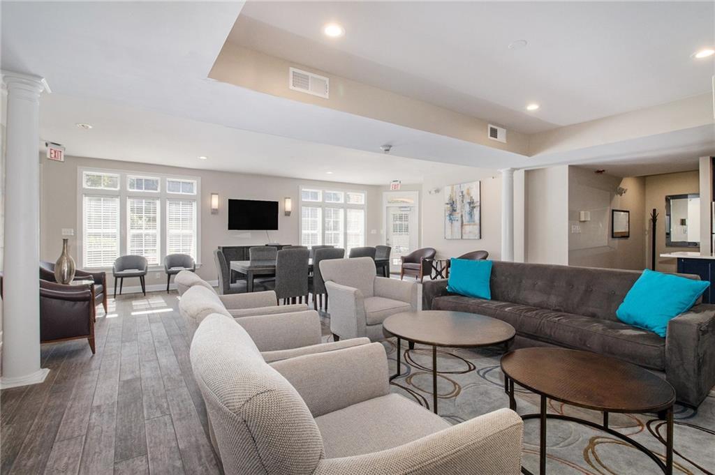 220 Renaissance Parkway Northeast, Unit 1211 Atlanta, GA 30308 - Photo 19 of 24 a living room with furniture and a flat screen tv