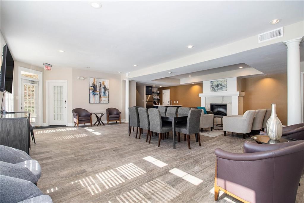 220 Renaissance Parkway Northeast, Unit 1211 Atlanta, GA 30308 - Photo 20 of 24 a living room with furniture and a table
