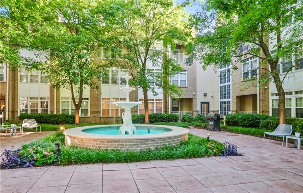 220 Renaissance Parkway Northeast, Unit 1211 Atlanta, GA 30308 - Photo 4 of 24 a view of a fountain in front of a brick house