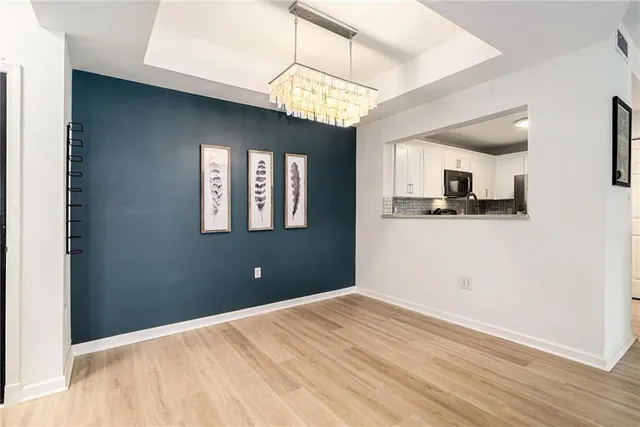 a view of a kitchen with a dishwasher cabinets and wooden floor