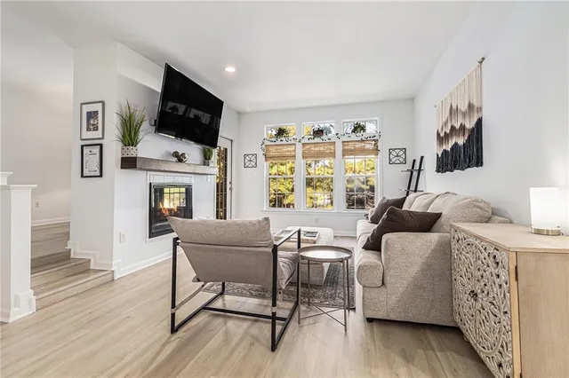 a living room with furniture a fireplace and a flat screen tv