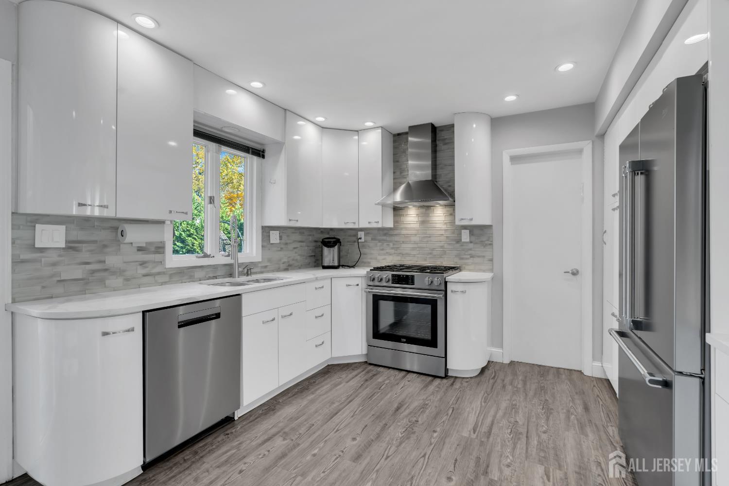4 Canadian Woods Road Marlboro, NJ 07746 - Photo 11 of 45 a kitchen with stainless steel appliances granite countertop a stove and a sink