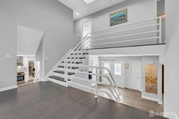 a view of entryway and hall with wooden floor