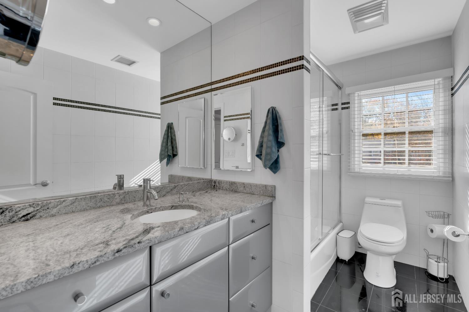 4 Canadian Woods Road Marlboro, NJ 07746 - Photo 24 of 45 a bathroom with a granite countertop sink toilet and shower