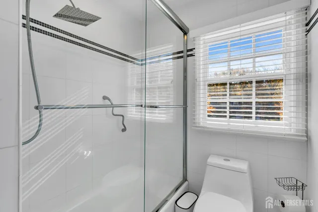 a bathroom with a shower and a toilet