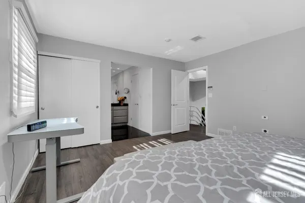 a bedroom with a sink and a mirror