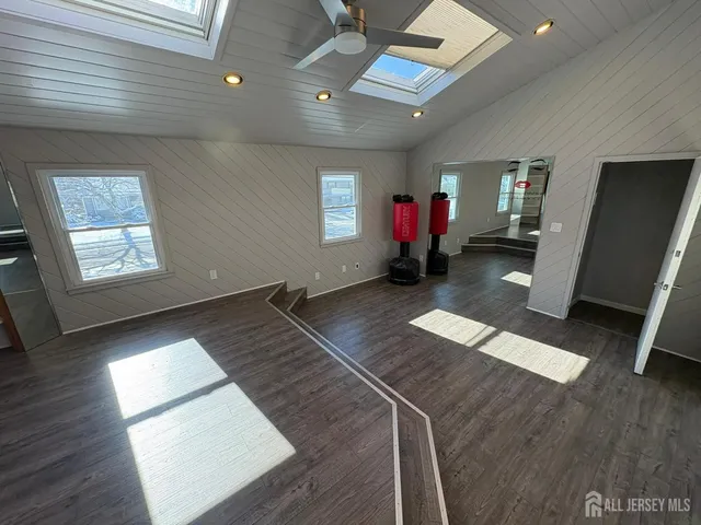 a view of a room with wooden floor and windows
