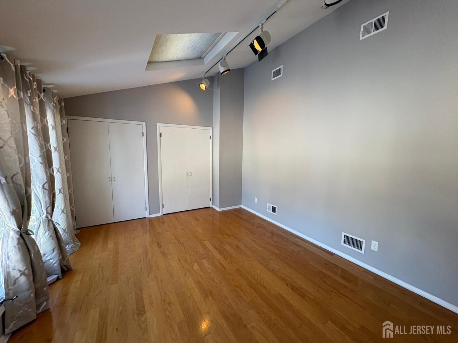 4 Canadian Woods Road Marlboro, NJ 07746 - Photo 36 of 45 a view of empty room with wooden floor and fan