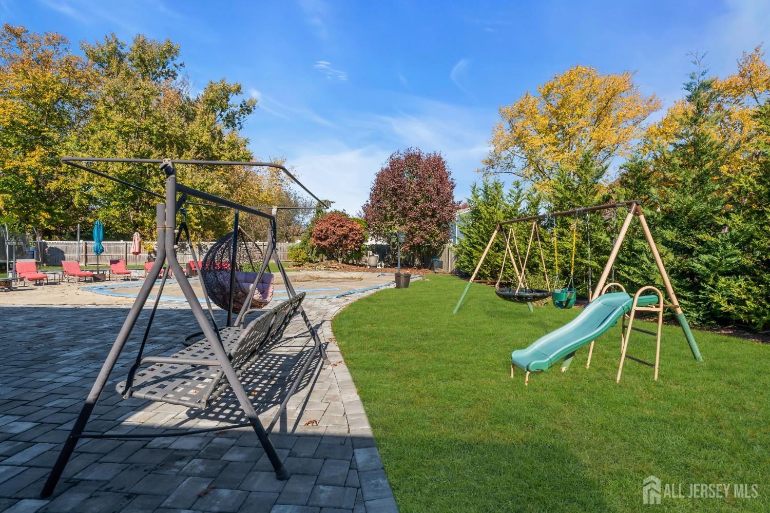 4 Canadian Woods Road Marlboro, NJ 07746 - Photo 42 of 45 a view of a backyard with a slide