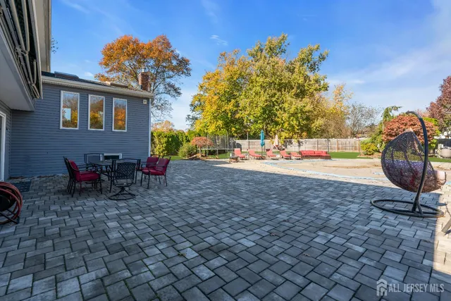 a view of a backyard with table and chairs