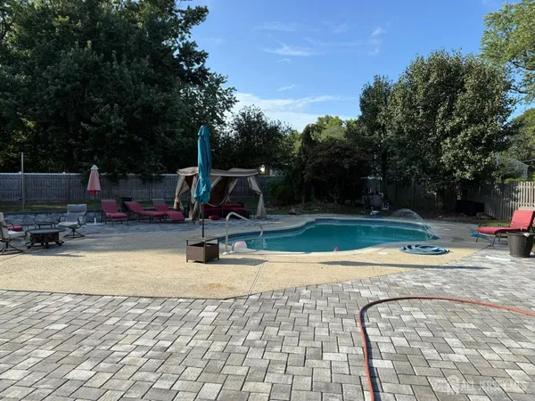 a view of a swimming pool with a patio