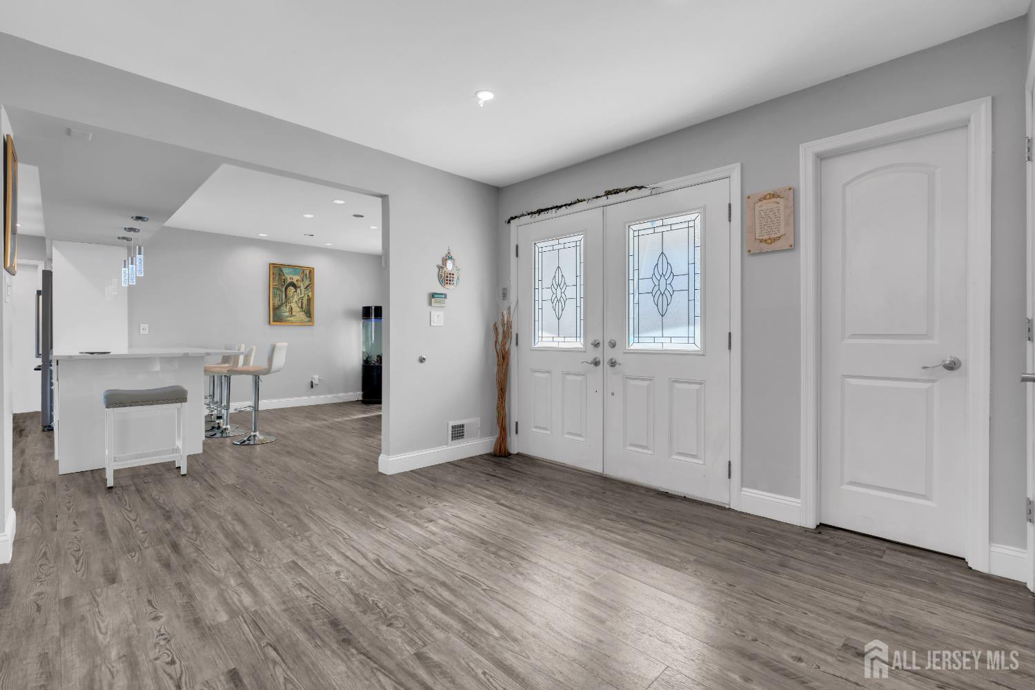 4 Canadian Woods Road Marlboro, NJ 07746 - Photo 7 of 45 an empty room with wooden floor and windows