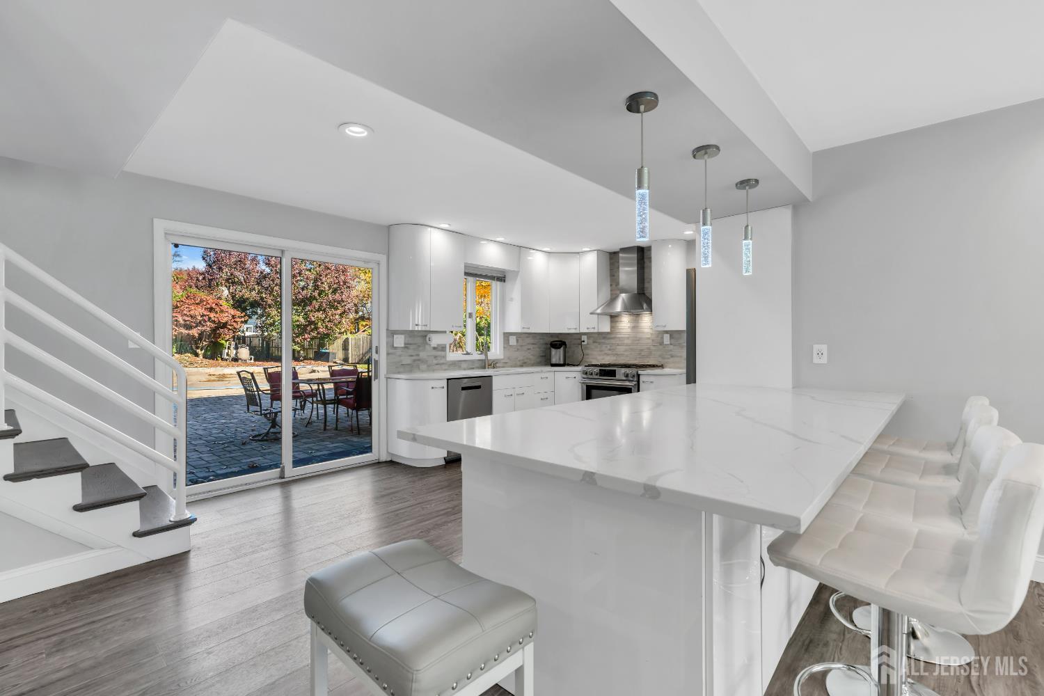 4 Canadian Woods Road Marlboro, NJ 07746 - Photo 10 of 45 a large white kitchen with a large window and stainless steel appliances