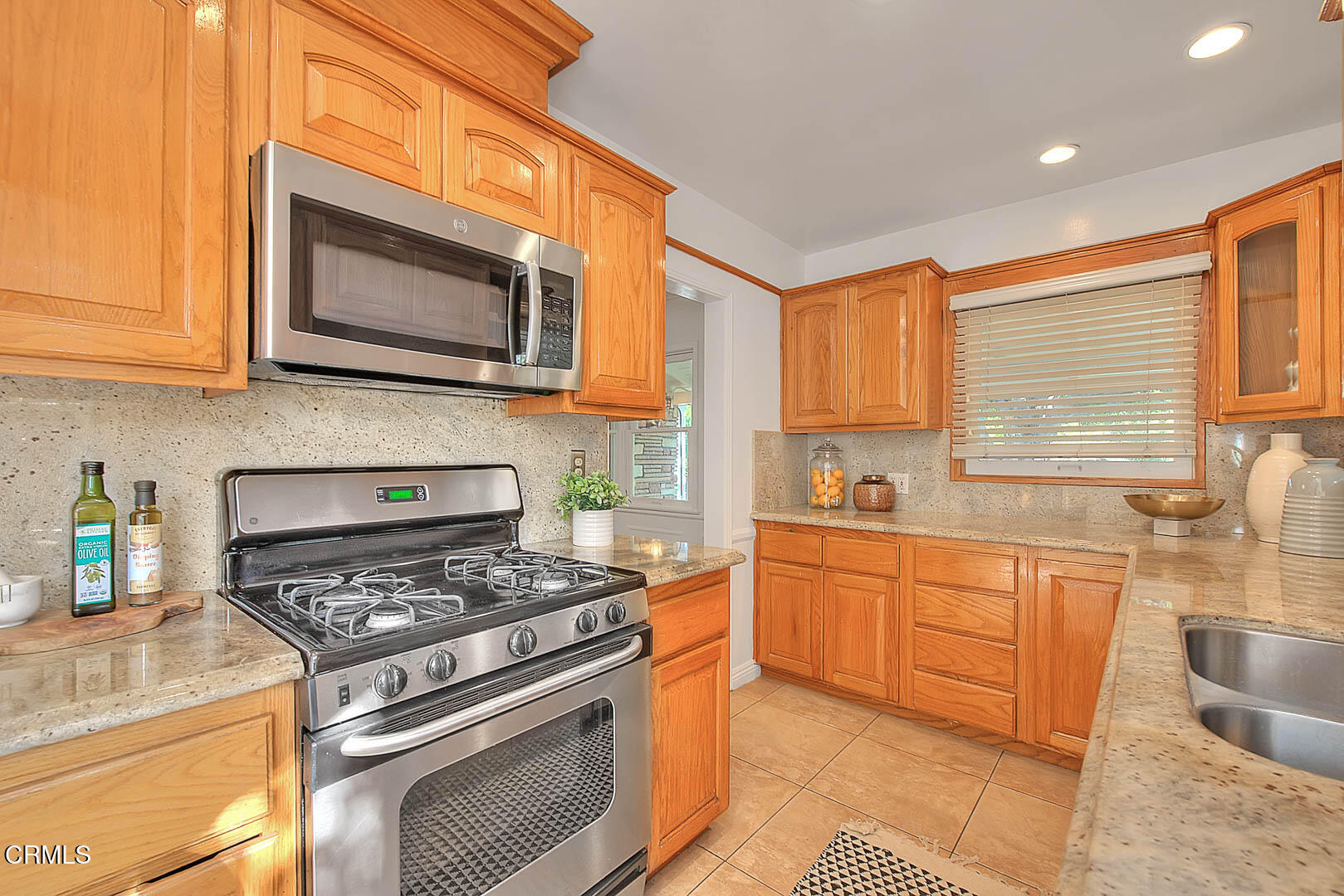 3671 Grayburn Road Pasadena, CA 91107 - Photo 13 of 50 a kitchen with stainless steel appliances granite countertop a stove a sink and a microwave