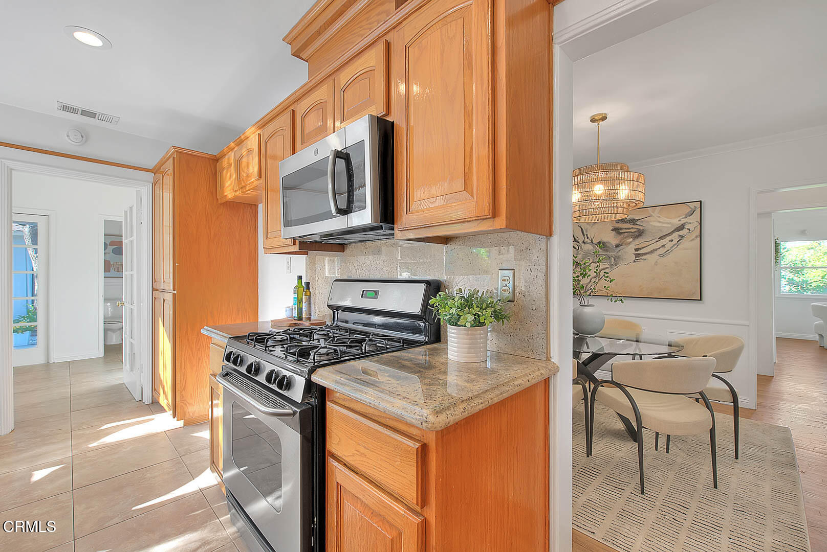 3671 Grayburn Road Pasadena, CA 91107 - Photo 17 of 50 a kitchen with stainless steel appliances granite countertop a stove a sink and a microwave