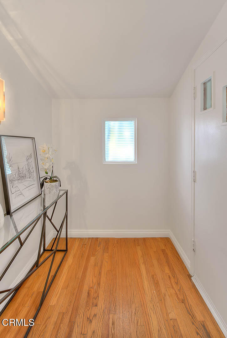 3671 Grayburn Road Pasadena, CA 91107 - Photo 6 of 50 a room with wooden floor and a table