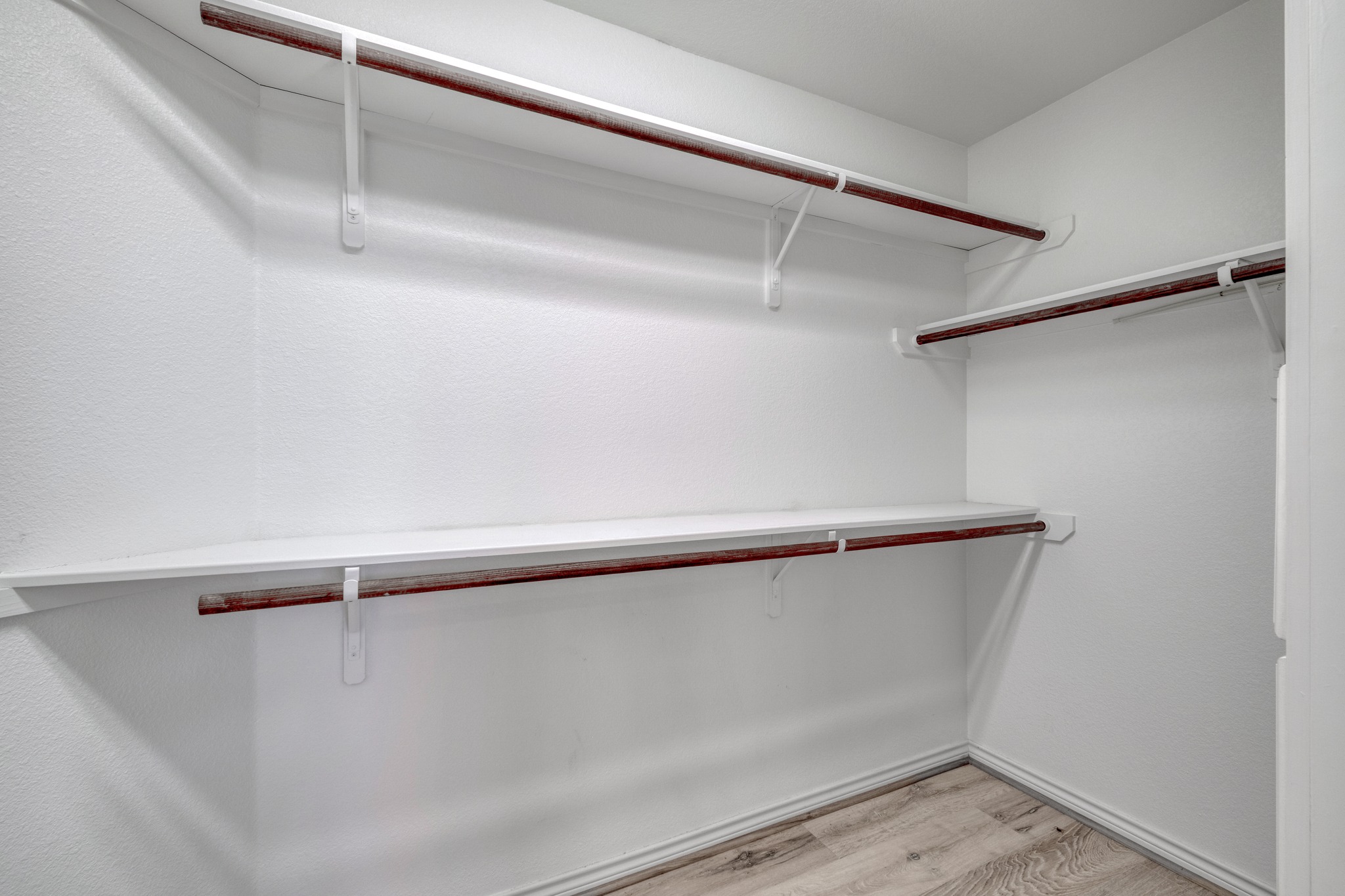 341 Brown Road McDade, TX 78650 - Photo 23 of 38 Ample shelving and hanging space defines this well-organized walk-in closet, ready for personalized storage solutions.
