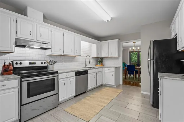 a kitchen with a stove top oven sink and refrigerator