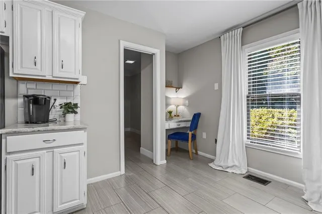 a view of kitchen with furniture and wooden floor