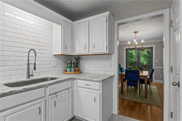 a kitchen with stainless steel appliances granite countertop white cabinets a sink and dishwasher
