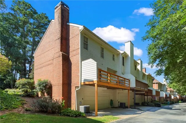 a view of a tall building next to a yard